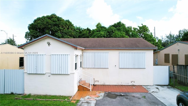 217 E 20th St, Hialeah, FL 33010 - view of front facade with stucco siding and a patio area