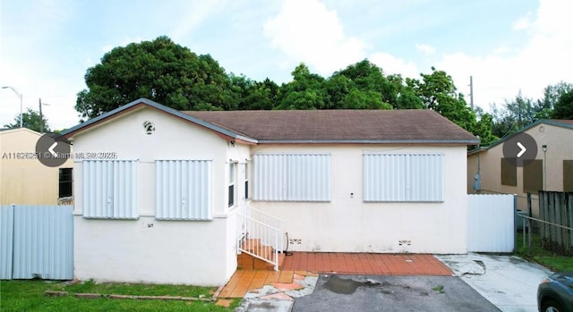 217 E 20th St, Hialeah, FL 33010 - view of front of home featuring stucco siding and roof with shingles