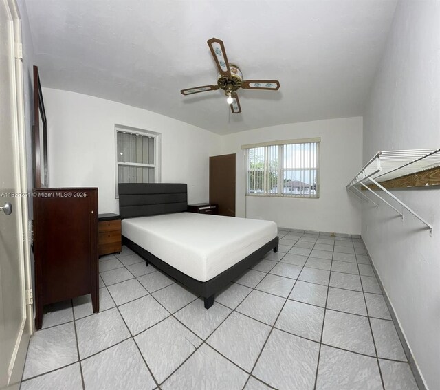 217 E 20th St, Hialeah, FL 33010 - bedroom with light tile patterned flooring and ceiling fan