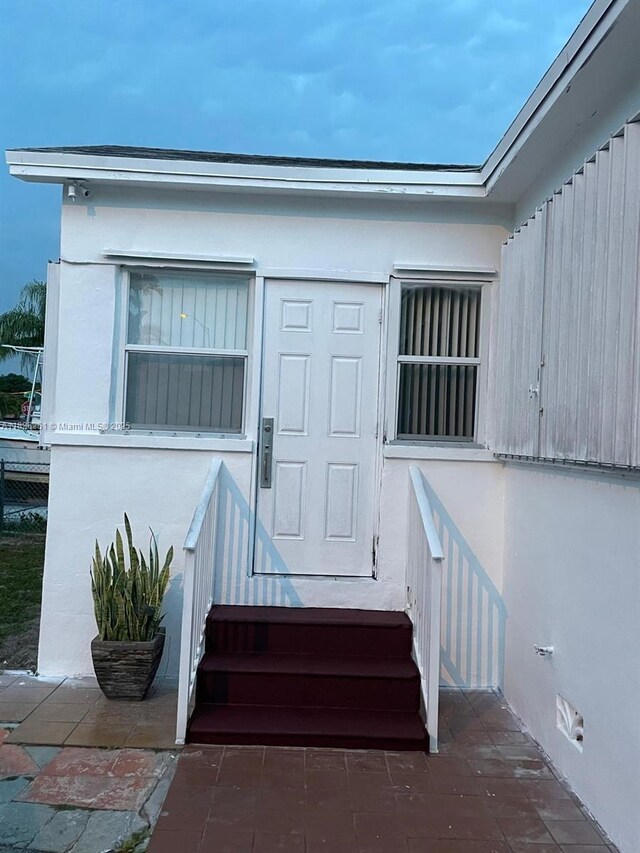 217 E 20th St, Hialeah, FL 33010 - doorway to property with stucco siding