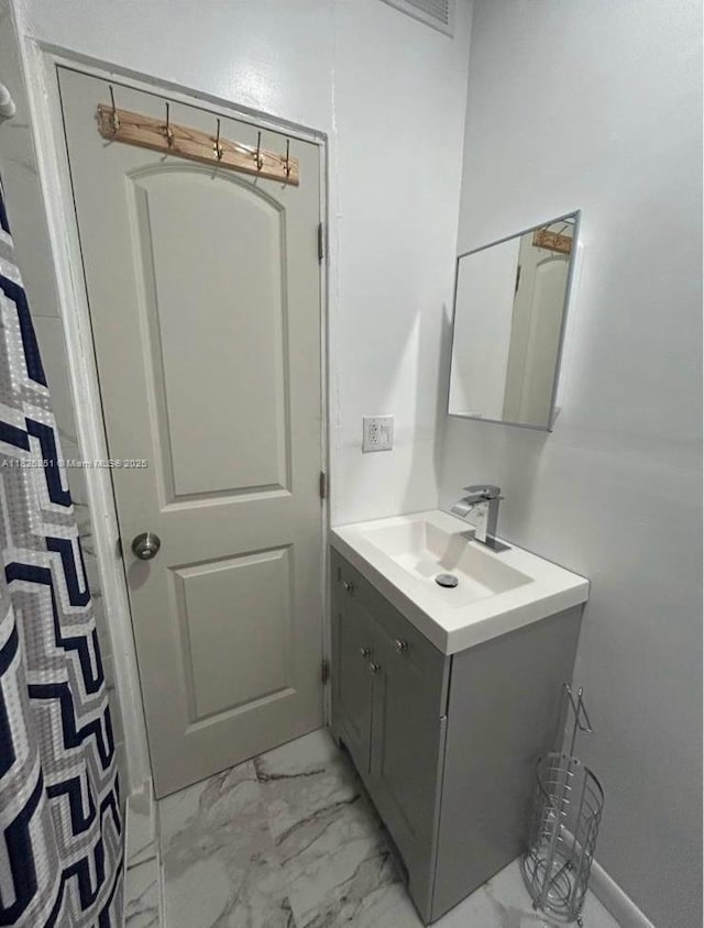 217 E 20th St, Hialeah, FL 33010 - bathroom with vanity and marble finish flooring
