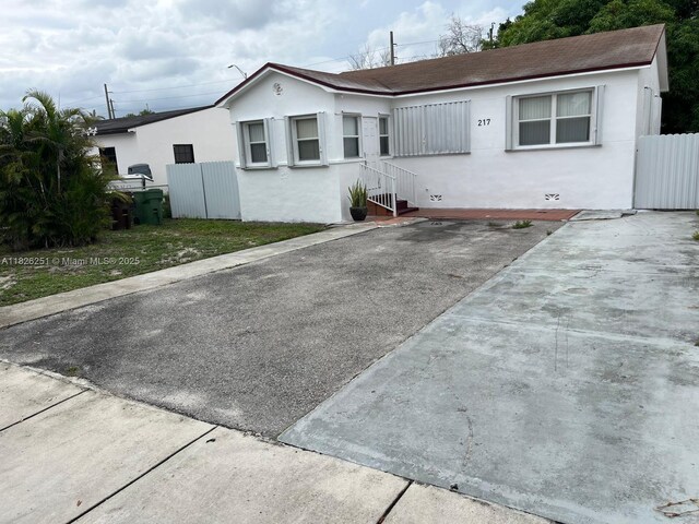 217 E 20th St, Hialeah, FL 33010 - view of front of property featuring stucco siding and roof with shingles