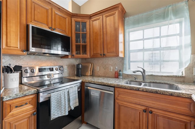 602 Lincoln Ct Unit 602, Deerfield Beach, FL 33442 - kitchen featuring stainless steel appliances, brown cabinets, light stone countertops, and glass insert cabinets