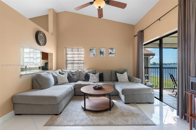 602 Lincoln Ct Unit 602, Deerfield Beach, FL 33442 - living room with ceiling fan, plenty of natural light, light tile patterned floors, high vaulted ceiling, and a water view