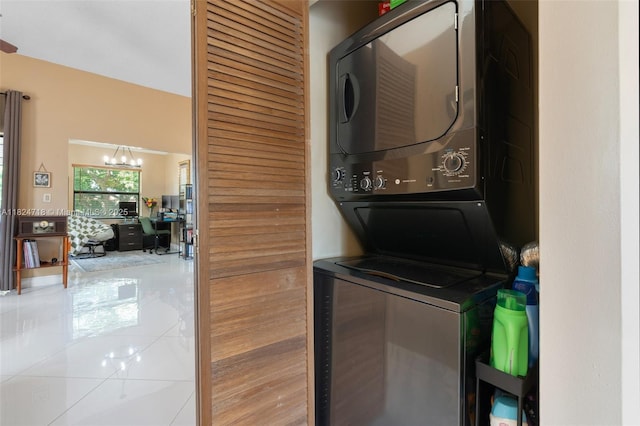 602 Lincoln Ct Unit 602, Deerfield Beach, FL 33442 - washroom with stacked washer / dryer, tile patterned flooring, a desk, and a chandelier
