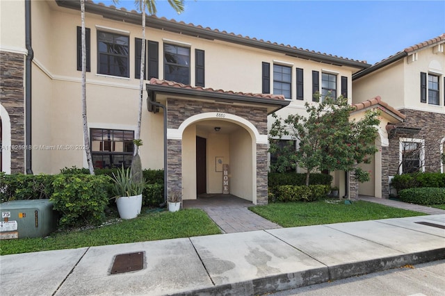 8880 W 35th Ct, Hialeah, FL 33018 - view of front of property with stone siding, stucco siding, and a tile roof