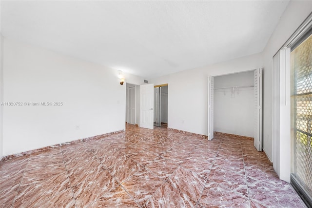 301 NW 177th St Unit 201, Miami Gardens, FL 33169 - unfurnished bedroom featuring two closets