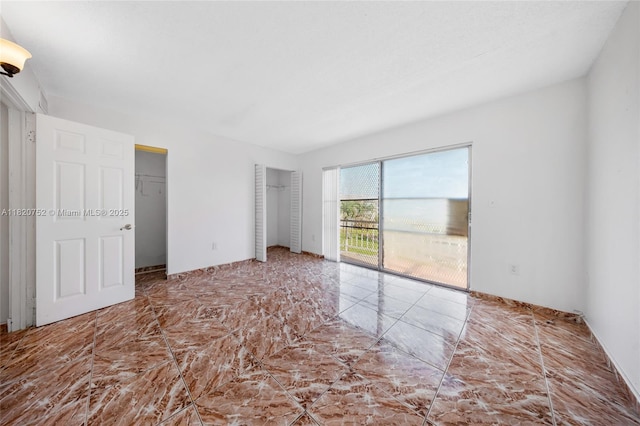 301 NW 177th St Unit 201, Miami Gardens, FL 33169 - unfurnished bedroom with access to outside and multiple closets