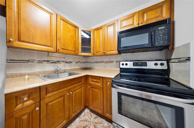 301 NW 177th St Unit 201, Miami Gardens, FL 33169 - kitchen featuring stainless steel electric range oven, black microwave, brown cabinets, light countertops, and backsplash