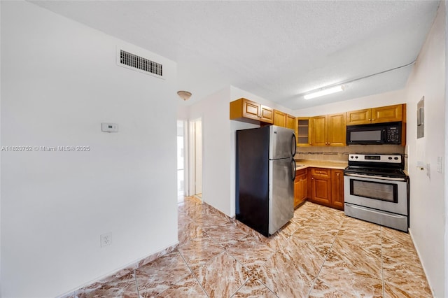 301 NW 177th St Unit 201, Miami Gardens, FL 33169 - kitchen featuring stainless steel appliances, light countertops, tasteful backsplash, a textured ceiling, and glass insert cabinets
