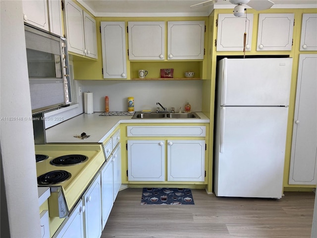 18707 NE 14th Ave Unit 638, Miami, FL 33179 - kitchen with freestanding refrigerator, ceiling fan, light countertops, light wood finished floors, and open shelves