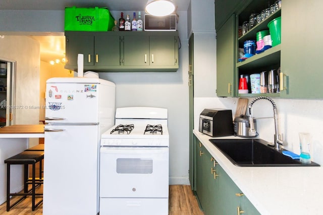 8420 Byron Ave Unit 6, Miami Beach, FL 33141 - kitchen featuring green cabinets, white appliances, and light wood-style flooring