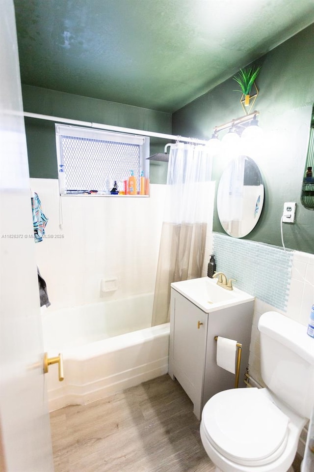 8420 Byron Ave Unit 6, Miami Beach, FL 33141 - bathroom featuring tile walls, vanity, wood finished floors, shower / bath combo, and wainscoting