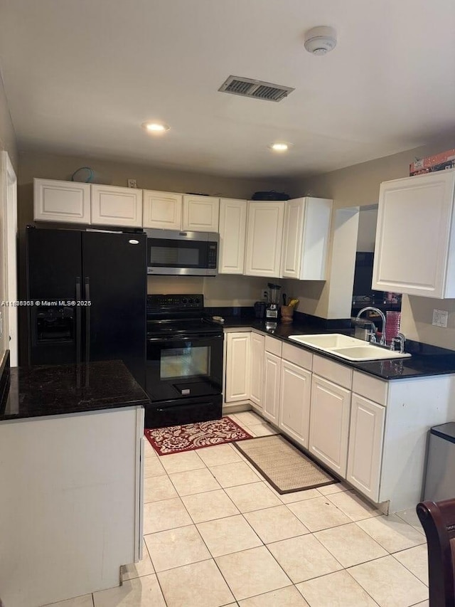 7301 SW 8th St, North Lauderdale, FL 33068 - kitchen featuring black appliances, dark countertops, white cabinetry, light tile patterned flooring, and recessed lighting