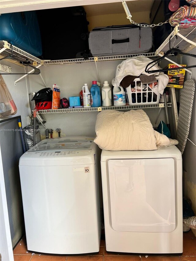 12922 SW 88th Ter Unit B-206, Miami, FL 33186 - washroom with washing machine and clothes dryer and tile patterned flooring