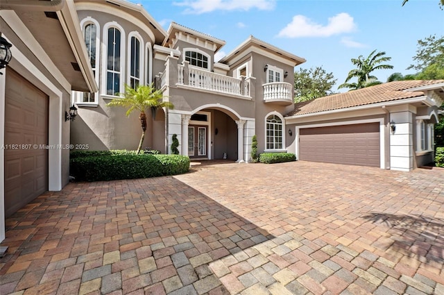 12608 S Stonebrook Cir, Davie, FL 33330 - mediterranean / spanish home with french doors, a balcony, stucco siding, and a garage