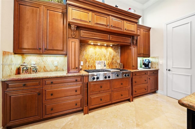 12608 S Stonebrook Cir, Davie, FL 33330 - kitchen featuring stainless steel gas cooktop, brown cabinets, tasteful backsplash, light stone countertops, and ornamental molding
