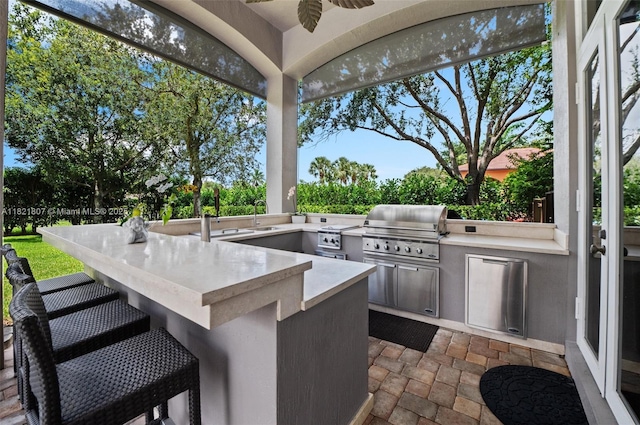 12608 S Stonebrook Cir, Davie, FL 33330 - view of patio featuring an outdoor kitchen and a ceiling fan