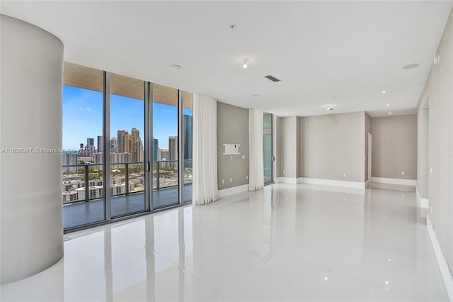 300 Sunny Isles Blvd Unit 4-Ts-04, Sunny Isles Beach, FL 33160 - tiled spare room featuring a view of skyline, expansive windows, fire sprinkler in ceiling, and recessed lighting