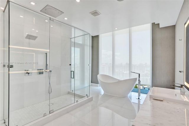 300 Sunny Isles Blvd Unit 4-Ts-04, Sunny Isles Beach, FL 33160 - bathroom with a wall of windows, a freestanding tub, a stall shower, tile patterned flooring, and vanity