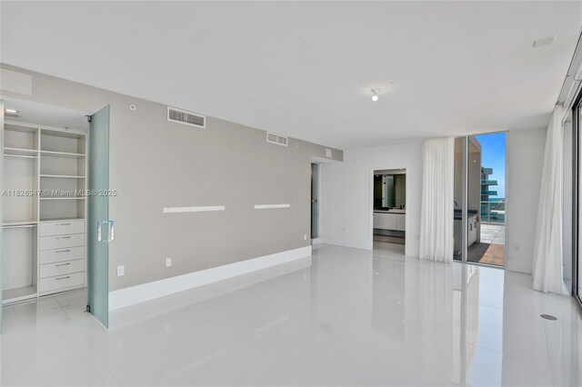 300 Sunny Isles Blvd Unit 4-Ts-04, Sunny Isles Beach, FL 33160 - tiled empty room featuring floor to ceiling windows and baseboards