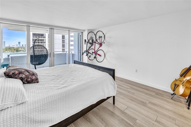 11 Island Ave Unit 1103, Miami Beach, FL 33139 - bedroom featuring wood finished floors, access to outside, french doors, and a view of city