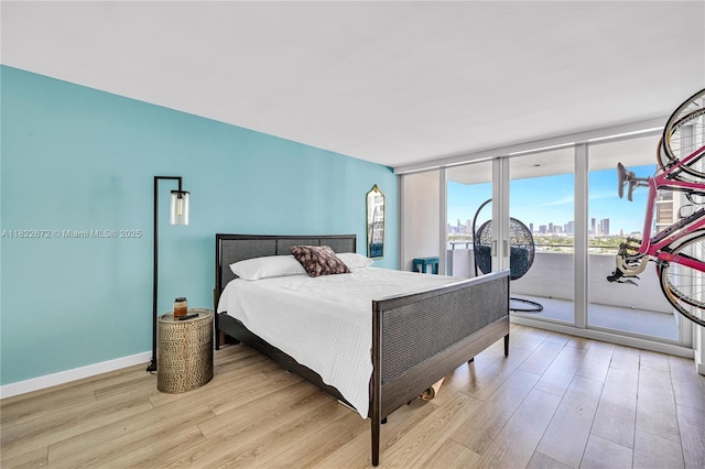 11 Island Ave Unit 1103, Miami Beach, FL 33139 - bedroom with wood finished floors, access to exterior, a wall of windows, and a city view