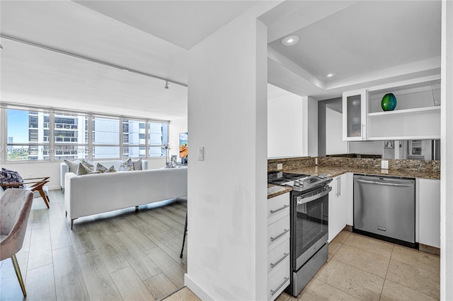 11 Island Ave Unit 1103, Miami Beach, FL 33139 - kitchen featuring appliances with stainless steel finishes, open shelves, white cabinetry, dark stone counters, and recessed lighting