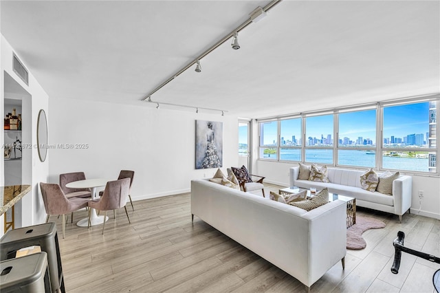 11 Island Ave Unit 1103, Miami Beach, FL 33139 - living area with a view of skyline, track lighting, light wood finished floors, and healthy amount of natural light