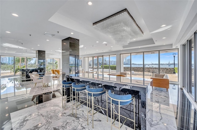 11 Island Ave Unit 1103, Miami Beach, FL 33139 - dining area with a tray ceiling, light marble finish flooring, and recessed lighting