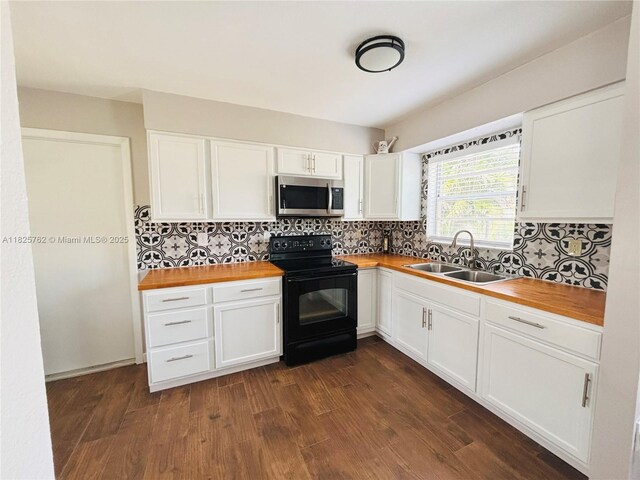 27064 Omni Ln, Punta Gorda, FL 33983 - kitchen featuring stainless steel microwave, black / electric stove, wooden counters, and dark wood finished floors