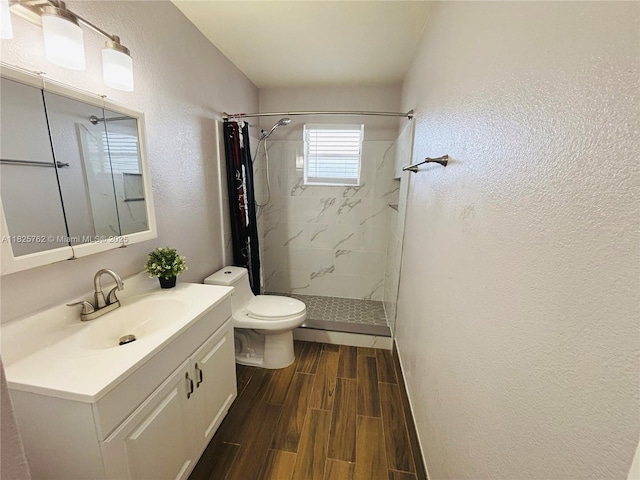 27064 Omni Ln, Punta Gorda, FL 33983 - bathroom featuring wood finished floors, a marble finish shower, vanity, and a textured wall