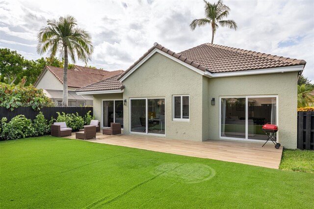 9248 Magnolia Ct, Davie, FL 33328 - rear view of house featuring stucco siding, a wooden deck, an outdoor hangout area, and a tile roof
