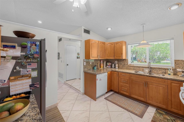 13245 SW 86th Ln, Miami, FL 33183 - kitchen featuring white dishwasher, freestanding refrigerator, backsplash, light stone counters, and a textured ceiling