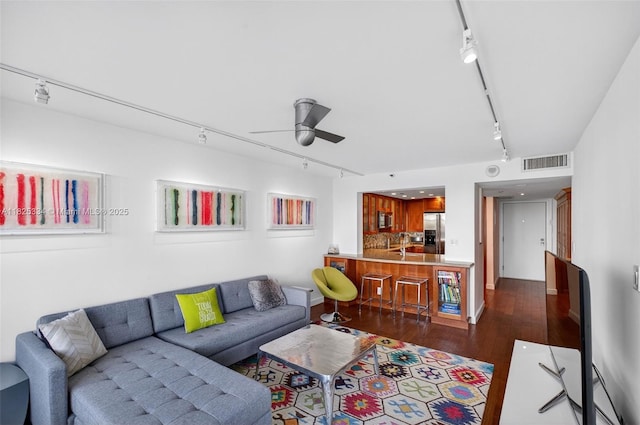 2555 Collins Ave Unit 606, Miami Beach, FL 33140 - living area with rail lighting, a ceiling fan, and dark wood-style floors