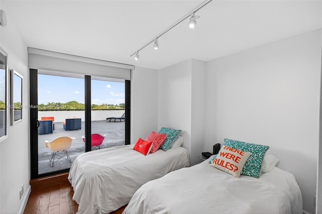 2555 Collins Ave Unit 606, Miami Beach, FL 33140 - bedroom featuring wood finished floors, track lighting, a water view, and access to outside
