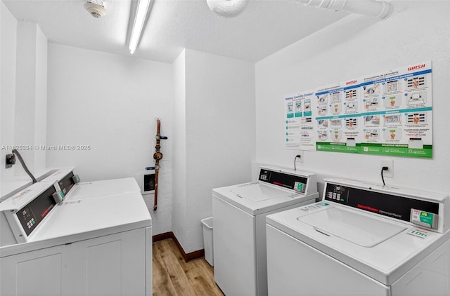 2555 Collins Ave Unit 606, Miami Beach, FL 33140 - shared laundry room with separate washer and dryer, light wood-type flooring, and a textured ceiling