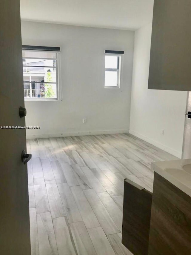 1560 Meridian Ave Unit 206, Miami Beach, FL 33139 - unfurnished room featuring wood finished floors and baseboards