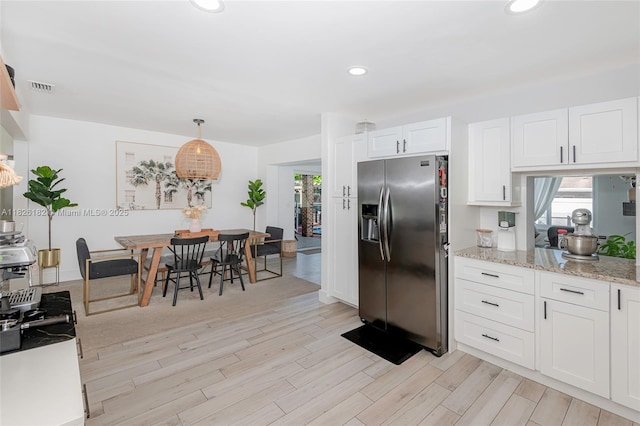 1770 NW 106th Ave, Pembroke Pines, FL 33026 - kitchen with stainless steel fridge, light wood-style floors, white cabinets, recessed lighting, and light stone countertops