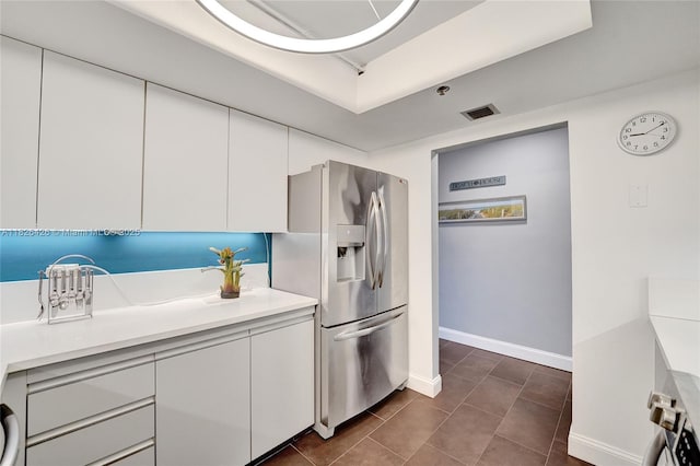 1201 S Ocean Dr Unit 218N, Hollywood, FL 33019 - kitchen with stainless steel fridge, white cabinets, and light countertops