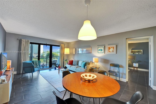 1201 S Ocean Dr Unit 218N, Hollywood, FL 33019 - dining space featuring a textured ceiling and dark tile patterned floors