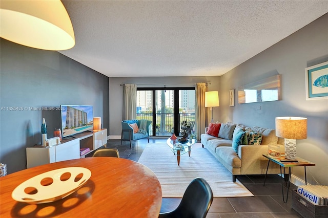 1201 S Ocean Dr Unit 218N, Hollywood, FL 33019 - living room featuring a textured ceiling and dark tile patterned flooring
