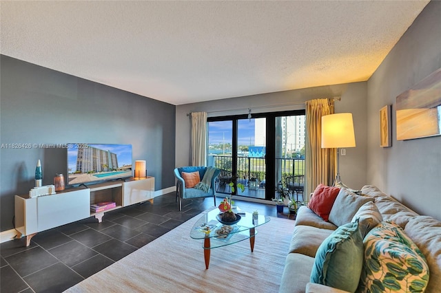 1201 S Ocean Dr Unit 218N, Hollywood, FL 33019 - living room featuring baseboards and a textured ceiling