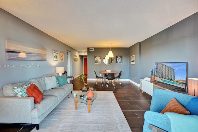 1201 S Ocean Dr Unit 218N, Hollywood, FL 33019 - living area featuring baseboards and dark tile patterned flooring