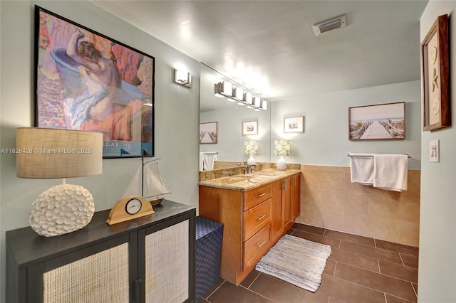 1201 S Ocean Dr Unit 218N, Hollywood, FL 33019 - full bath with vanity, tile patterned floors, tile walls, and wainscoting