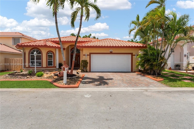 11581 SW 10th Ct, Pembroke Pines, FL 33025 - mediterranean / spanish-style house featuring stucco siding, driveway, a garage, and a tiled roof