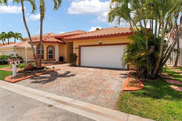 11581 SW 10th Ct, Pembroke Pines, FL 33025 - mediterranean / spanish home featuring an attached garage, a tile roof, decorative driveway, and stucco siding