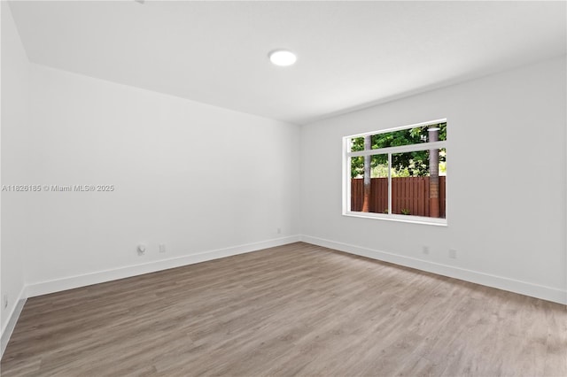 11581 SW 10th Ct, Pembroke Pines, FL 33025 - empty room with wood finished floors and baseboards