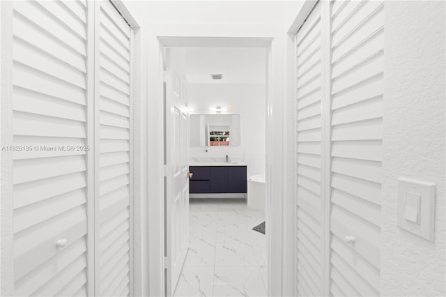 11581 SW 10th Ct, Pembroke Pines, FL 33025 - hall featuring light marble finish floors and a sink