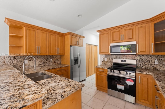11581 SW 10th Ct, Pembroke Pines, FL 33025 - kitchen featuring stainless steel appliances, lofted ceiling, light stone counters, light tile patterned flooring, and decorative backsplash